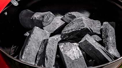 Natural hardwood lump charcoal burning on grill for Korean BBQ